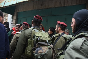 VFP member Tarak Kauff asks IDF soldiers why they are forcing Palestinians off their own market street. PHOTO: ELLEN DAVIDSON