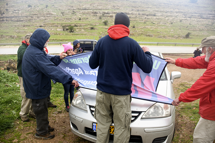 Another settler arrives in a car and pushes up against Matt's knees. PHOTO: ELLEN DAVIDSON