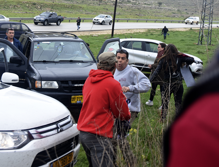 Meanwhile another settler arrives and starts assaulting one of the women. Mike goes over and the guy takes a swing at him. PHOTO: ELLEN DAVIDSON