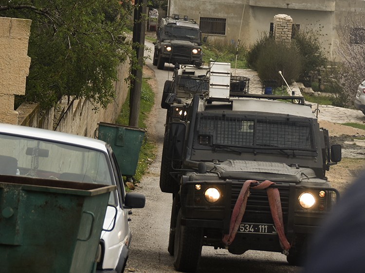 We go back to the village, and the soldiers come up the road to our host's house in jeeps. PHOTO: ELLEN DAVIDSON